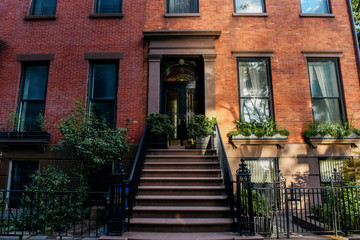 Brownstone facades & row houses at sunset in an iconic neighborhood of Brooklyn Heights in New York City