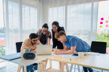 A Business people team looking at laptop computer and paper of work discussing for work diagram and project in office company with business meeting concept.