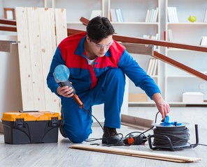 Young carpenter working with wooden planks