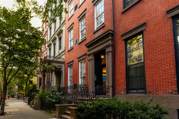 Brownstone facades & row houses at sunset in an iconic neighborhood of Brooklyn Heights in New York City