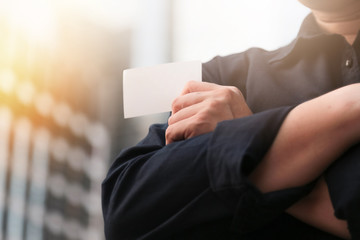 Confident male business executive with empty white business card
