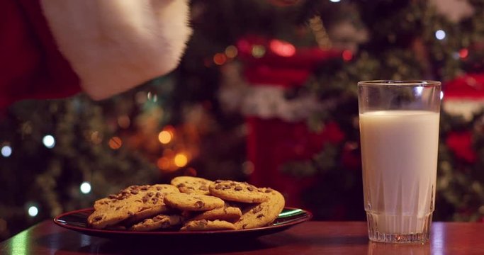 Santa dramatically dunking a cookie into a glass of milk - shot on RED