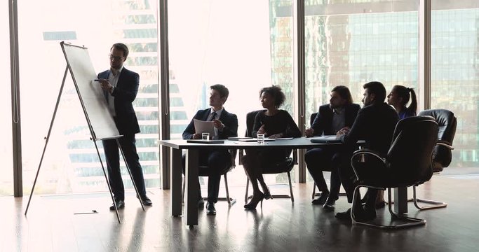 Businessman conference speaker give flip chart presentation teaching team people