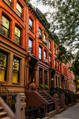 Brownstone facades & row houses at sunset in an iconic neighborhood of Brooklyn Heights in New York City