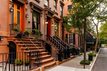 Brownstone facades & row houses at sunset in an iconic neighborhood of Brooklyn Heights in New York...