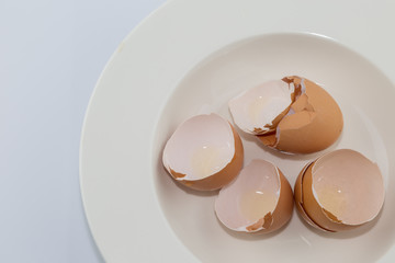 Egg shell on white plate diet concept