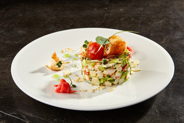 Olivier salad with crab meat and shrimps on white plate