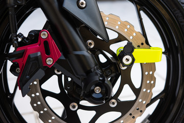 Obraz premium Close Up of Yellow Disc Lock on Motorcycle Disc Brake