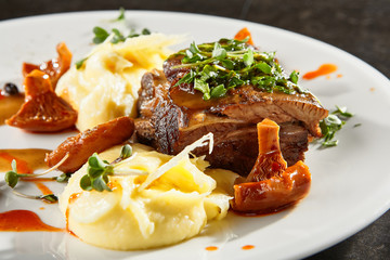 Beef brisket and mashed potato on white plate