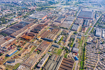 Fototapeta premium aerial view of factory or plant industrial area with many industrial buildings in city outskirts