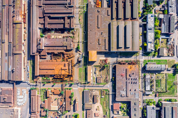 aerial top down view of rusty roofs of industrial buildings and warehouses