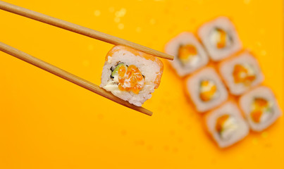 Japanese rolls on yellow background.