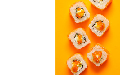 Japanese rolls on yellow background.