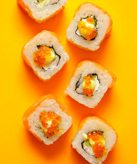 Japanese rolls on yellow background.