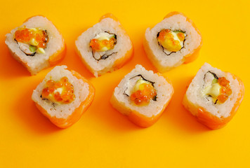 Japanese rolls on yellow background.
