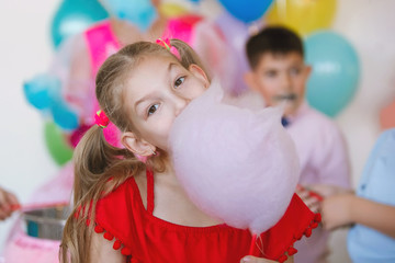 Teenager girl with cotton candy at celebration.