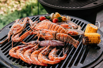 Lobster and mix seafood barbecue cokking on grill