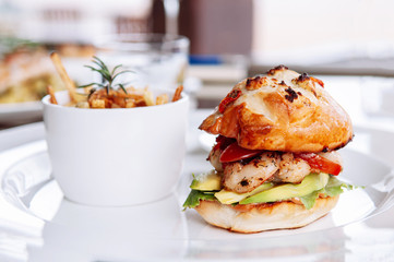 Baked grilled prawn burger with Avocado Aloli sauce and tomato in crispy bun