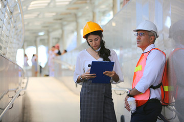 Portrait of multiethnic architect with blueprints and business industrial man engineer at construction building