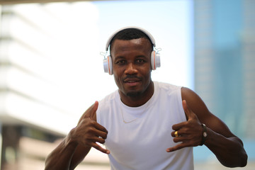 Head shot of Sportsman African american with headphone listening music outside on street