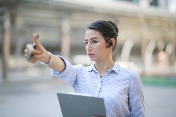 Portrait of young beautiful business woman smiling and show thumb up at outside. 