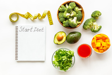 Diet program mockup. Start diet text in notebook near vegetables on white background top view