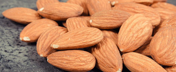 Almonds as source minerals and fiber. Wooden background