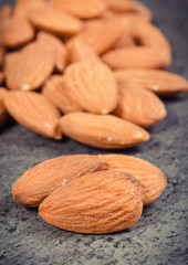 Almonds as source minerals and fiber. Wooden background