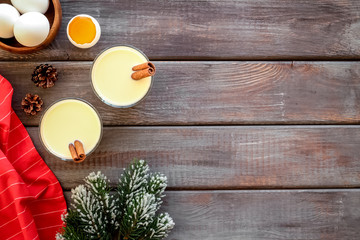 Make festive drink eggnog - ingredients on dark wooden background top view frame copy space