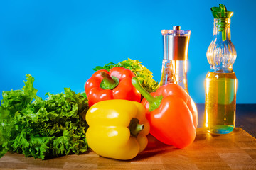 Fresh vegetables, spices and olive oil. The components of a Greek salad. Cooking Greek salad at home. Quick and easy recipe. Wholesome food. Recipe from Greece.