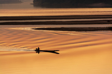 Fishermen drive boats on the river
