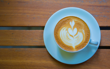 Top view  a cup of coffee  late art on wooden table