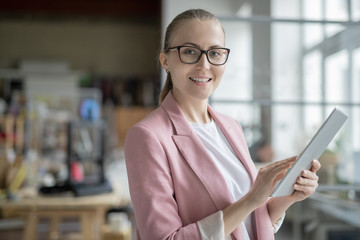 Successful businesswoman using digital tablet while preparing presentation