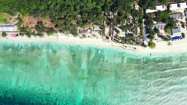 The Cook Islands - A Tropical Paradise Of Green Trees, White Sand, And Villas Surrounded By Bright Blue Sea Waters On A Sunny Day - Aerial Drone