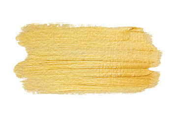 Gold paint brush stroke isolated on white background. Golden metallic make-up smear swatch sample