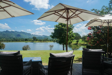 close up  comfortable sofa with outdoor garden parasol in bright sunny day for rest in summer © jummie