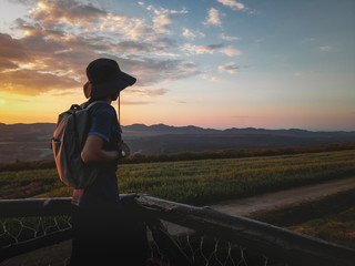 Young man traveler backpacker looking view beautiful nature landscape and twilight sky background. Lifestyle relaxation concept