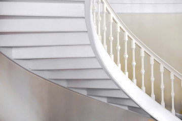 Curved view of under the white vintage stairs.