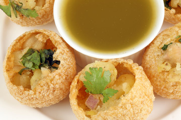 Tadeonal subcontinental street snack food chickpeas potato pani puri fuska with tamarind sauce © oqba