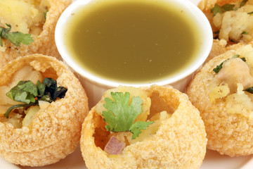 Tadeonal subcontinental street snack food chickpeas potato pani puri fuska with tamarind sauce © oqba