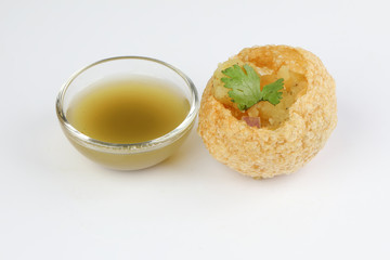 Tadeonal subcontinental street snack food chickpeas potato pani puri fuska with tamarind sauce
