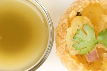 Tadeonal subcontinental street snack food chickpeas potato pani puri fuska with tamarind sauce © oqba