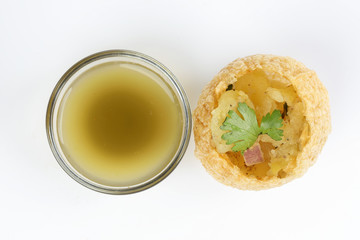 Tadeonal subcontinental street snack food chickpeas potato pani puri fuska with tamarind sauce