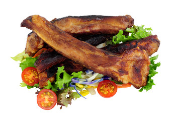 Grilled pork ribs with fresh salad isolated on a white background