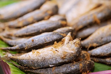 Close up pile of fried mackerel fish in tahi street food market