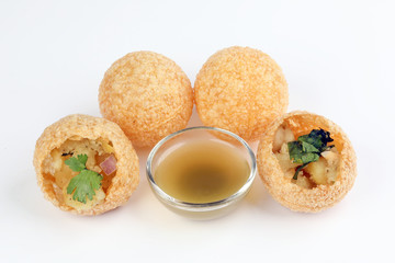 Tadeonal subcontinental street snack food chickpeas potato pani puri fuska with tamarind sauce