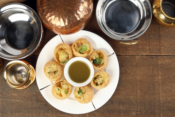 Tadeonal subcontinental street snack food chickpeas potato pani puri fuska with tamarind sauce