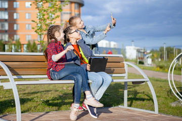 Children and gadgets in the city park.