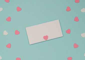 Valentine's Day blue background with white envelope and pink and white hearts. Valentine greeting card. Flat lay style.