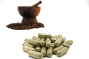 closeup the black pepper in Wooden mortar on white background , selective focus. Herbal Medicines.